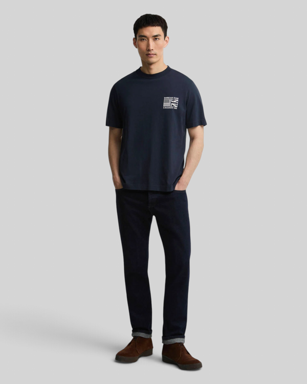 Baffle Haus model wearing a navy blue 100% cotton Steve McQueen graphic t-shirt with a crew neck and open cuffs.