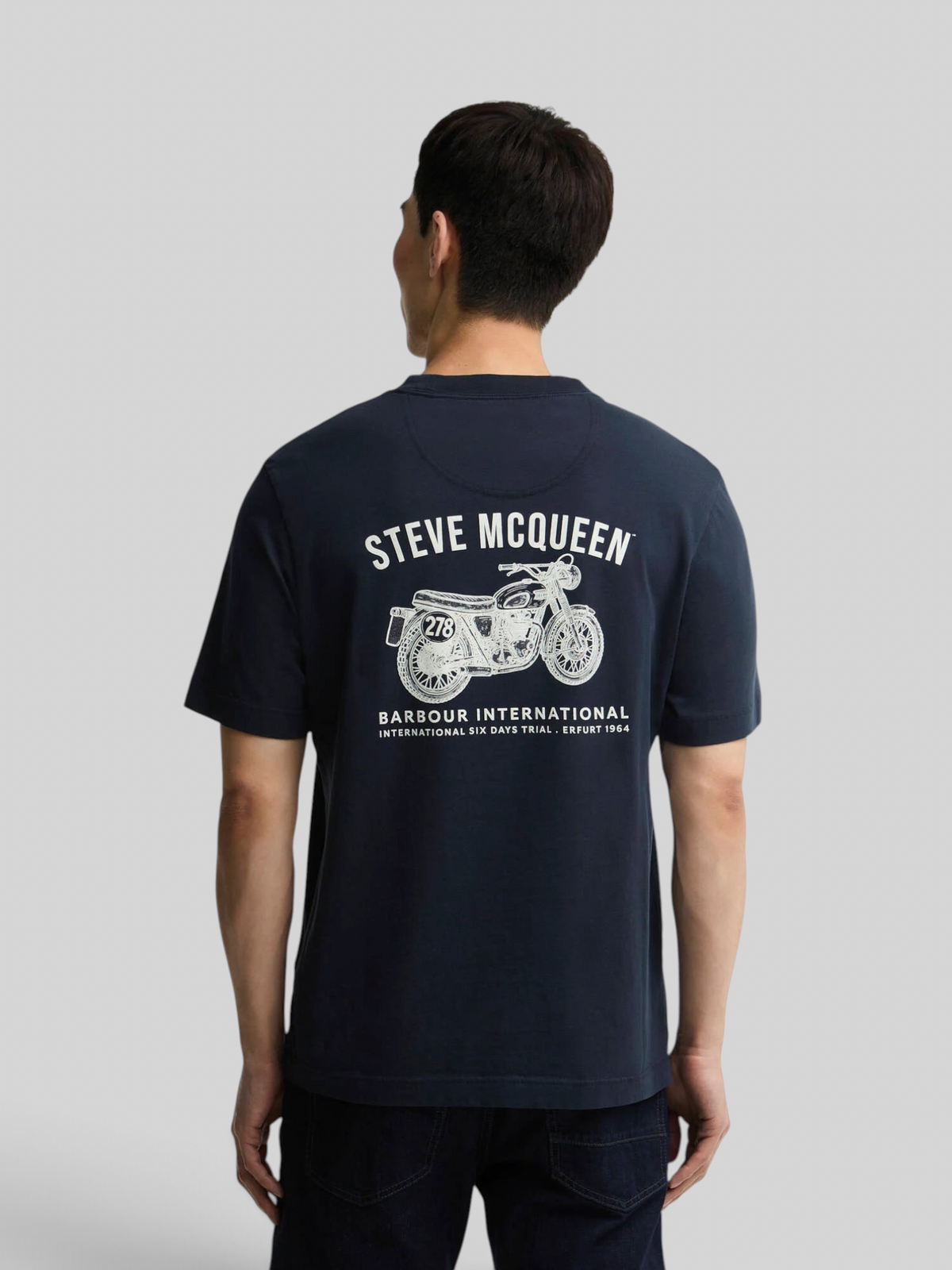 Baffle Haus navy cotton t-shirt with Steve McQueen motorcycle graphic print on the back worn by a man