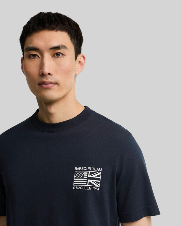 Baffle Haus navy cotton crew neck t-shirt featuring a white Barbour Team Steve McQueen graphic print on the chest.