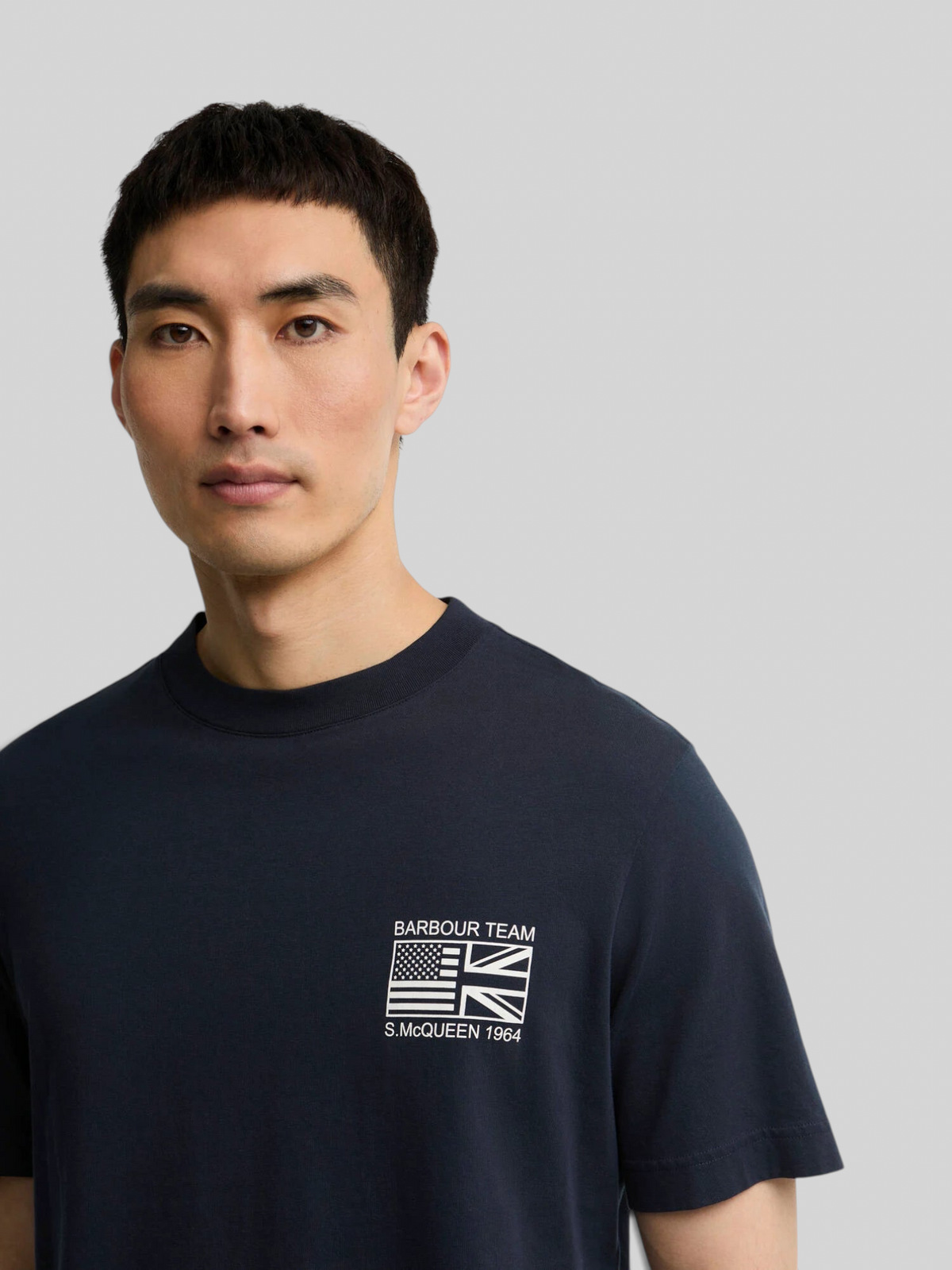 Baffle Haus navy cotton crew neck t-shirt featuring a white Barbour Team Steve McQueen graphic print on the chest.