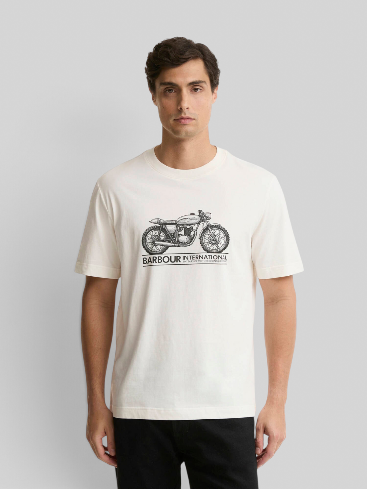 Baffle Haus model wearing a whisper white Barbour International cotton crew neck t-shirt with a motorbike graphic.