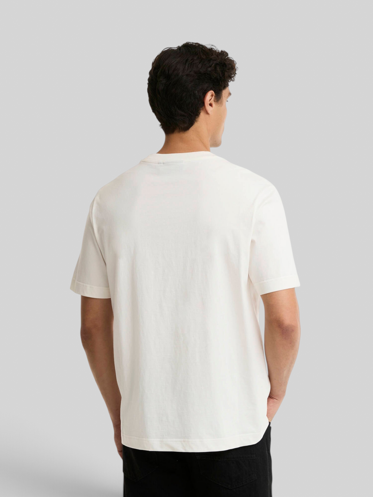 Back view of a man wearing a Baffle Haus Barbour International Triton cotton T-shirt in whisper white