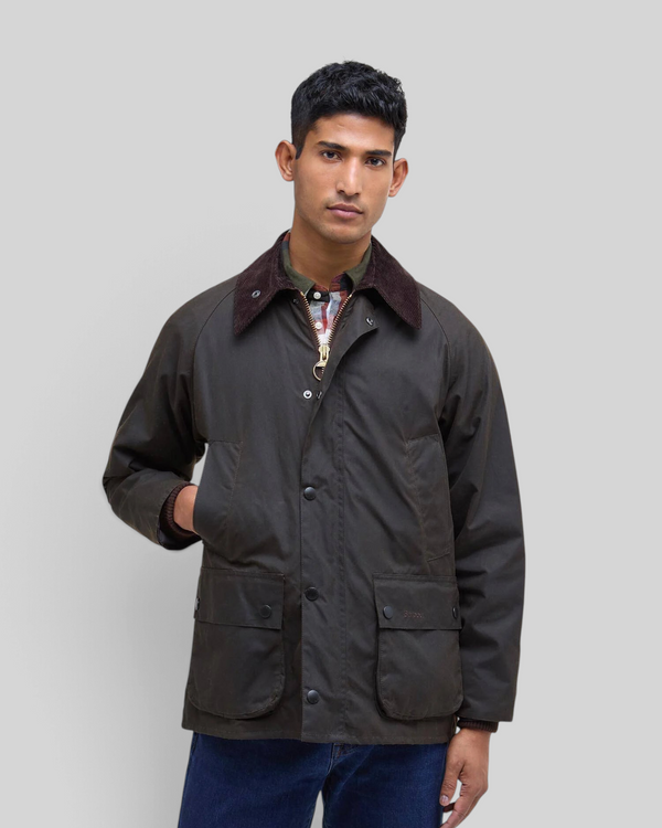 Baffle Haus Barbour Bedale olive waxed cotton jacket with corduroy collar worn by a man against a grey background