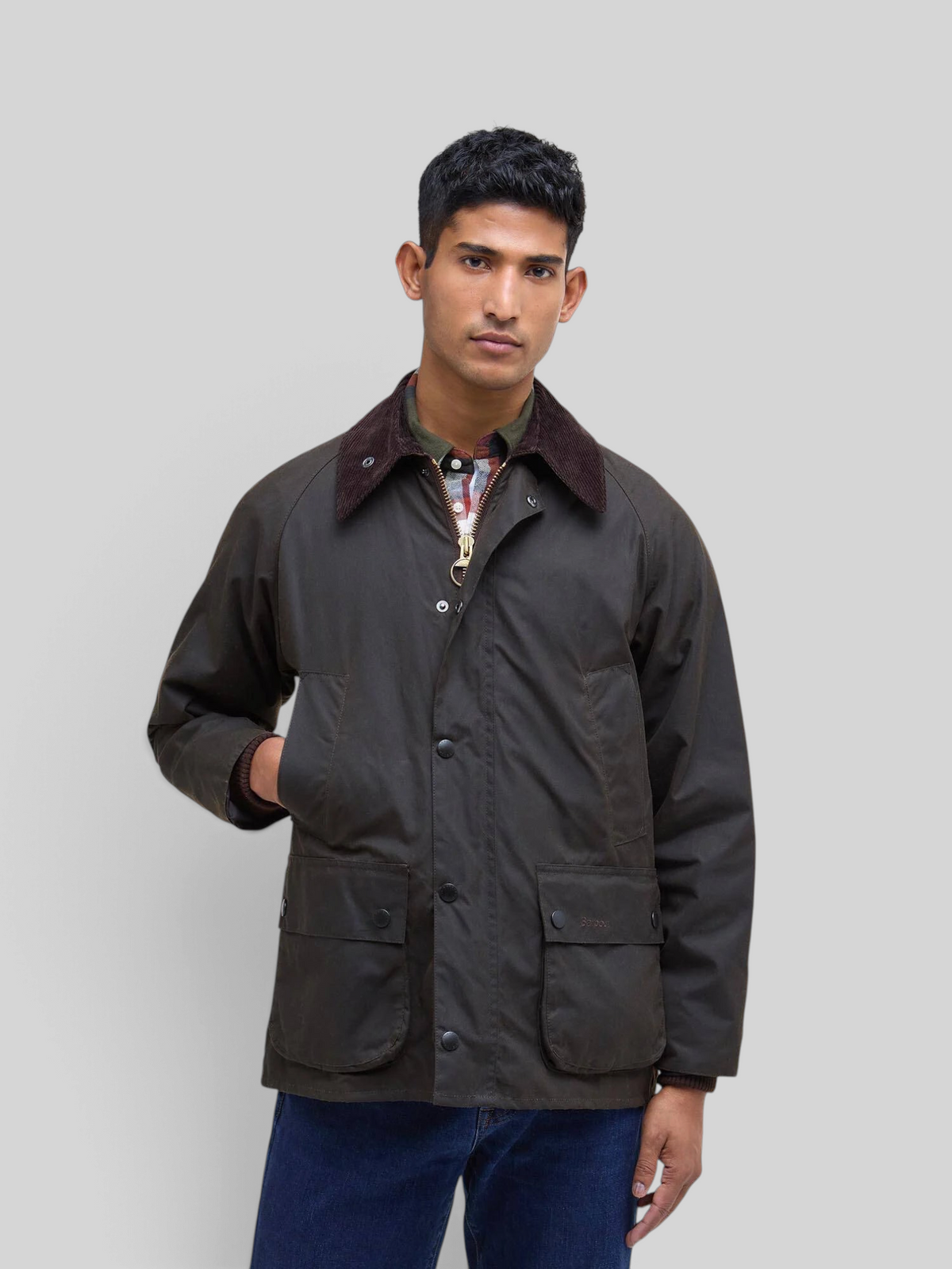 Baffle Haus Barbour Bedale olive waxed cotton jacket with corduroy collar worn by a man against a grey background