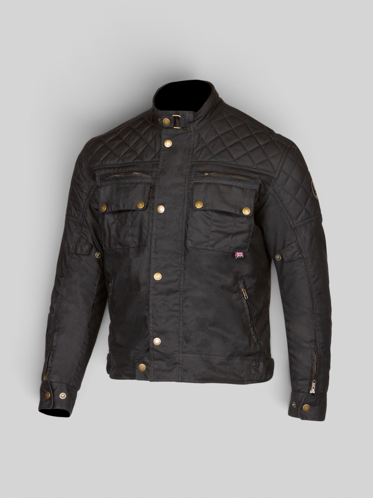 Baffle Haus Stanton AAA black waxed cotton motorcycle jacket with quilted shoulders and brass hardware details.