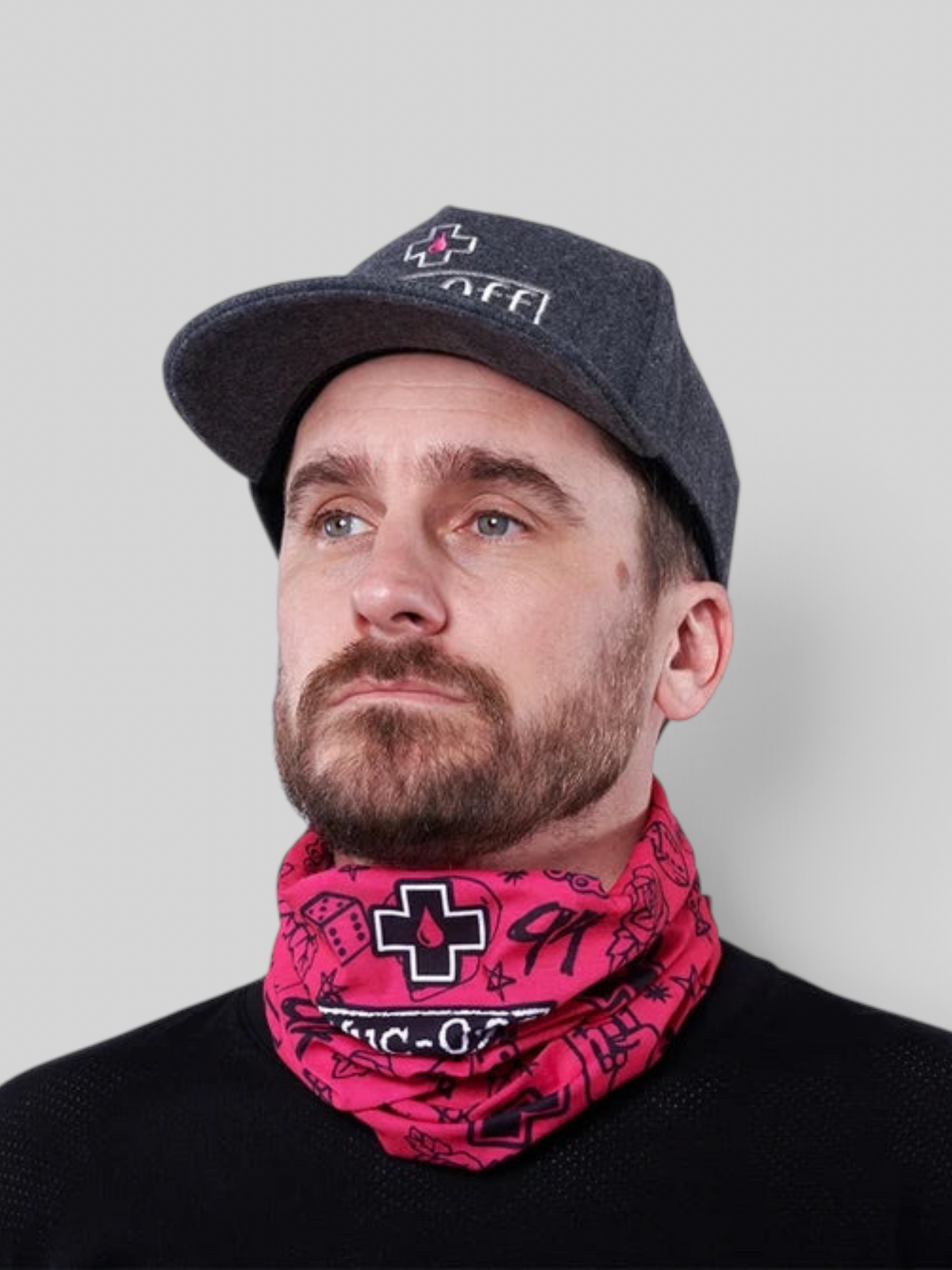 Baffle Haus pink punk neck tube gaiter worn by a man in a grey cap, featuring a seamless polyester design.