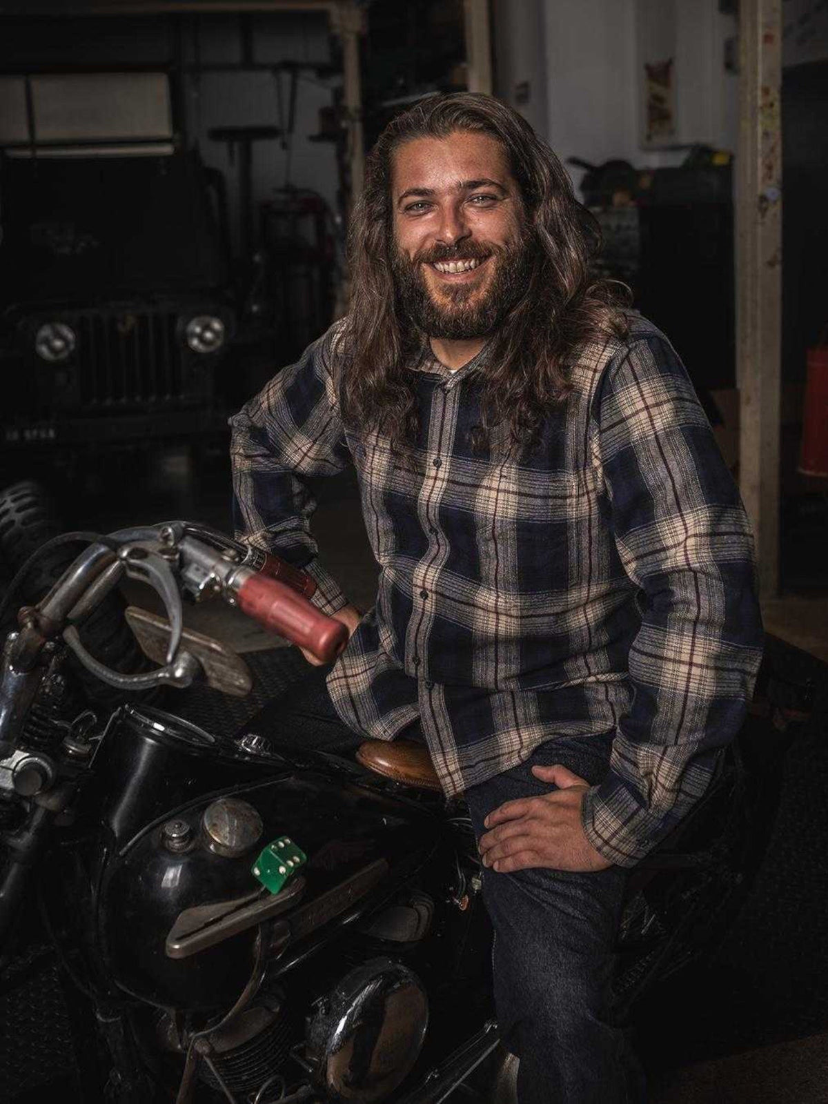 Baffle Haus 1937 Roamer Shirt in navy and beige plaid cotton worn by a man sitting on a vintage motorcycle