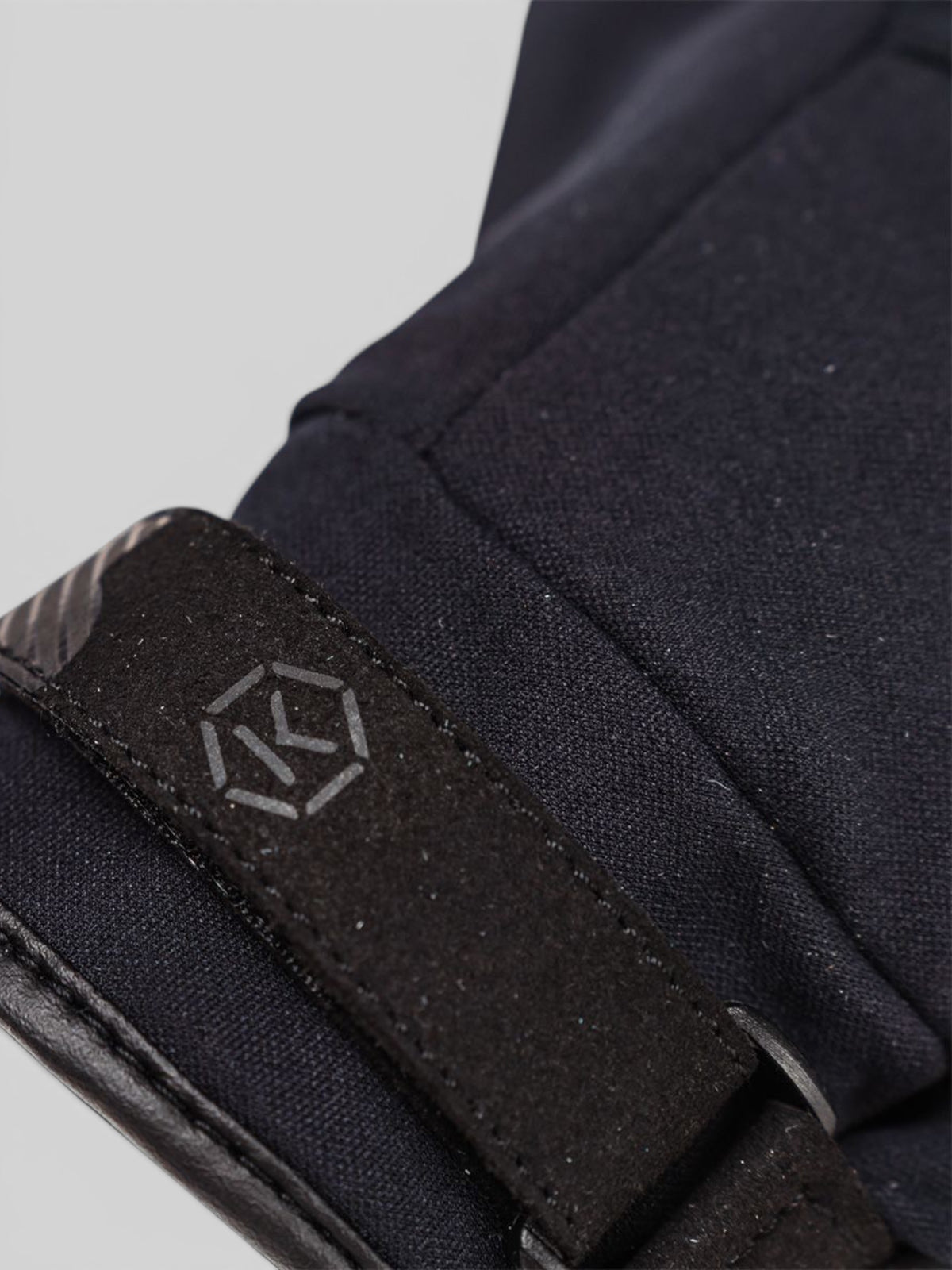 Baffle Haus Action Pro waterproof motorcycle glove in black featuring a velcro wrist strap with logo detail