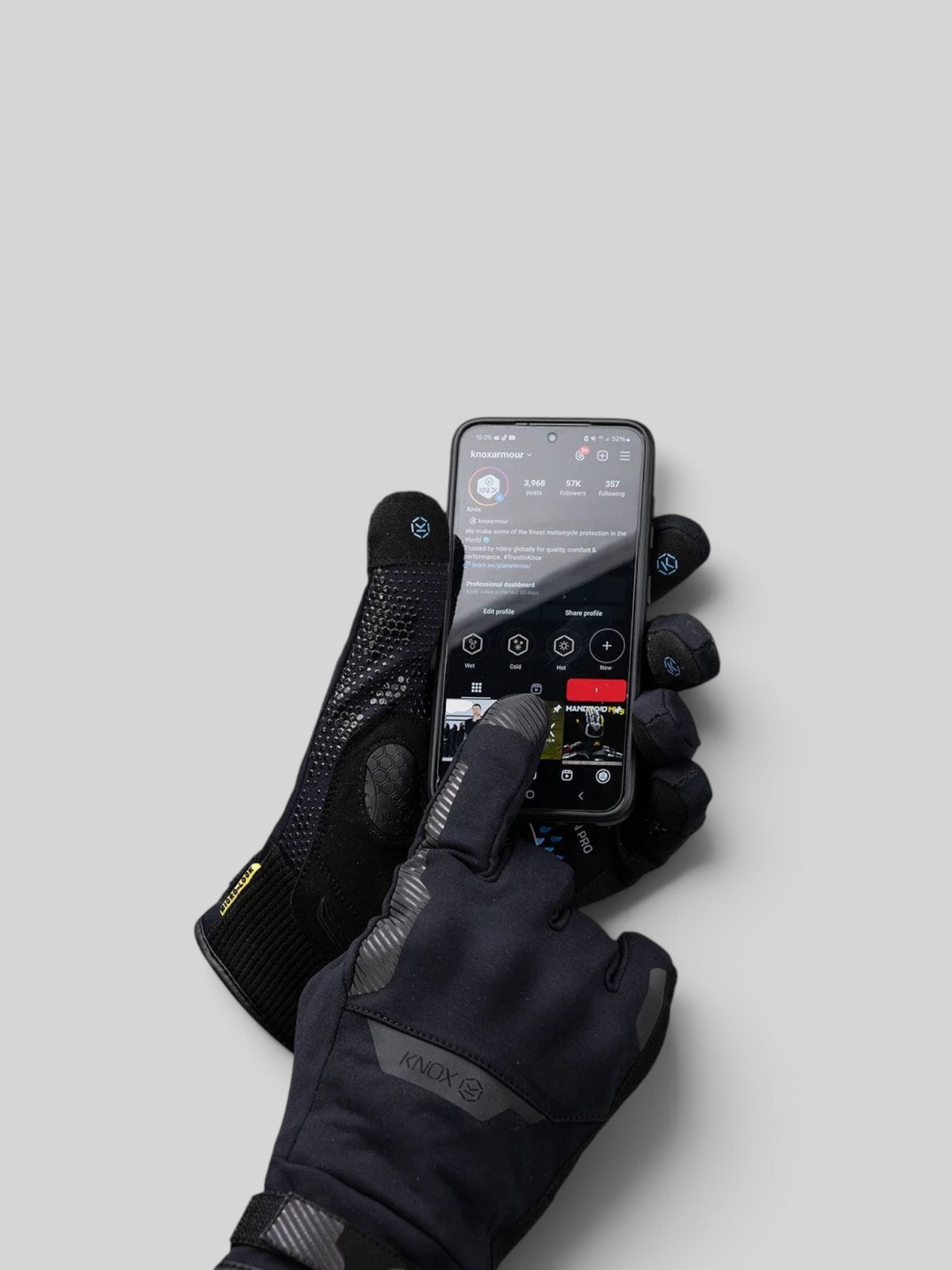 Baffle Haus Action Pro waterproof motorcycle gloves in black with touchscreen-compatible fingertips and knuckle armor.