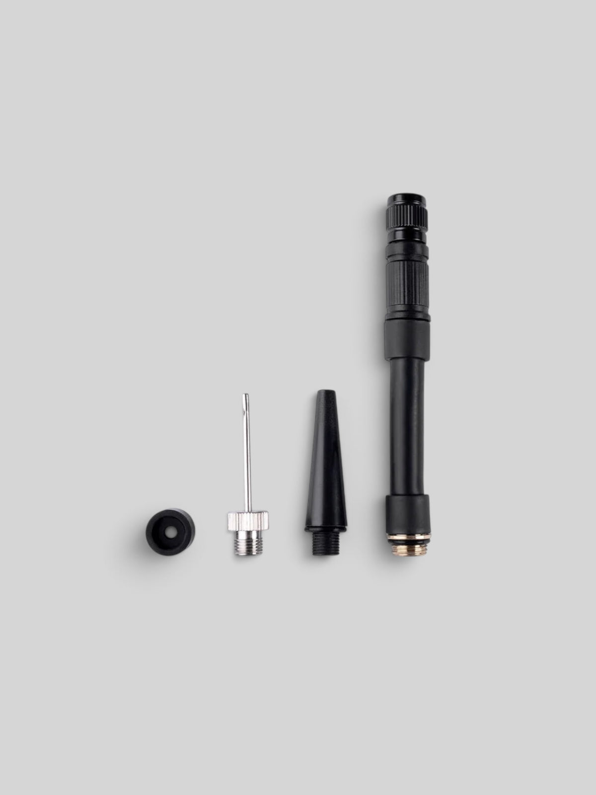 Baffle Haus AirMach Electric Pro Inflator nozzle attachments including needle and valve adapters on grey background