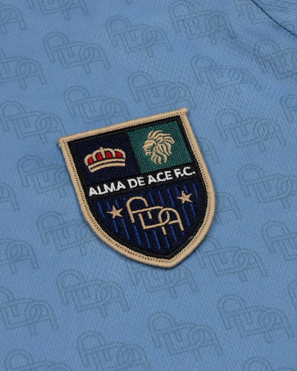 Baffle Haus Alma De Ace F.C. light blue football jersey featuring a detailed embroidered club crest patch