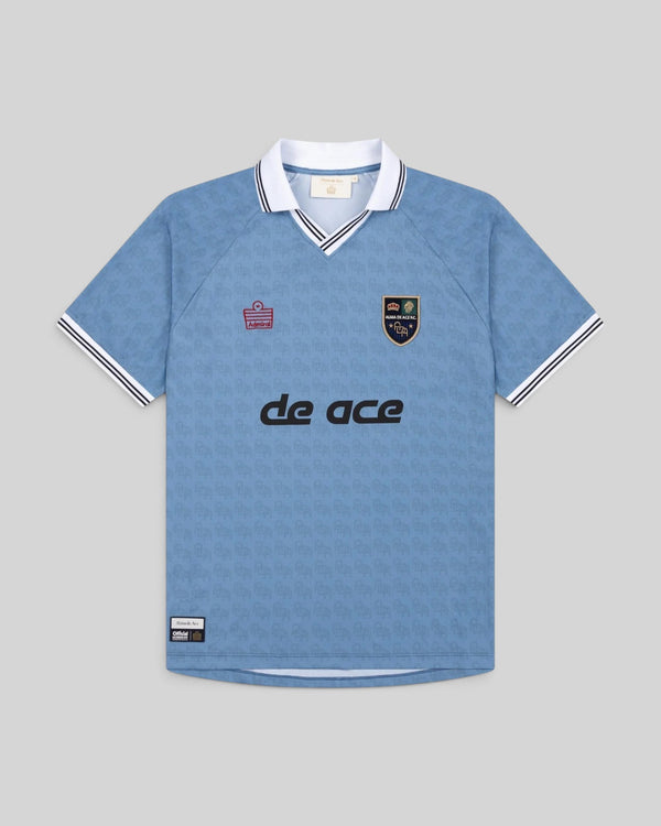 Baffle Haus Alma De Ace light blue football away top with white collar, black trim, and patterned fabric
