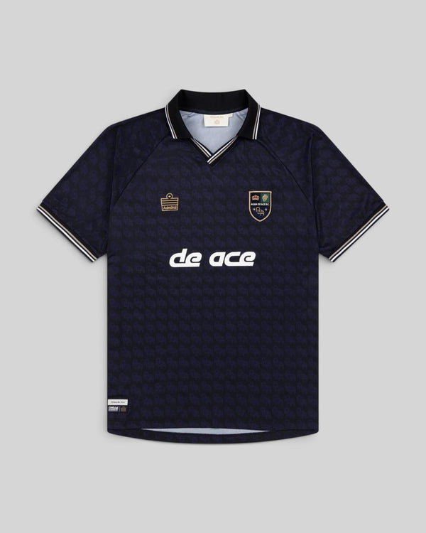 Baffle Haus Alma De Ace navy blue football home jersey with a collared neckline and patterned fabric design.
