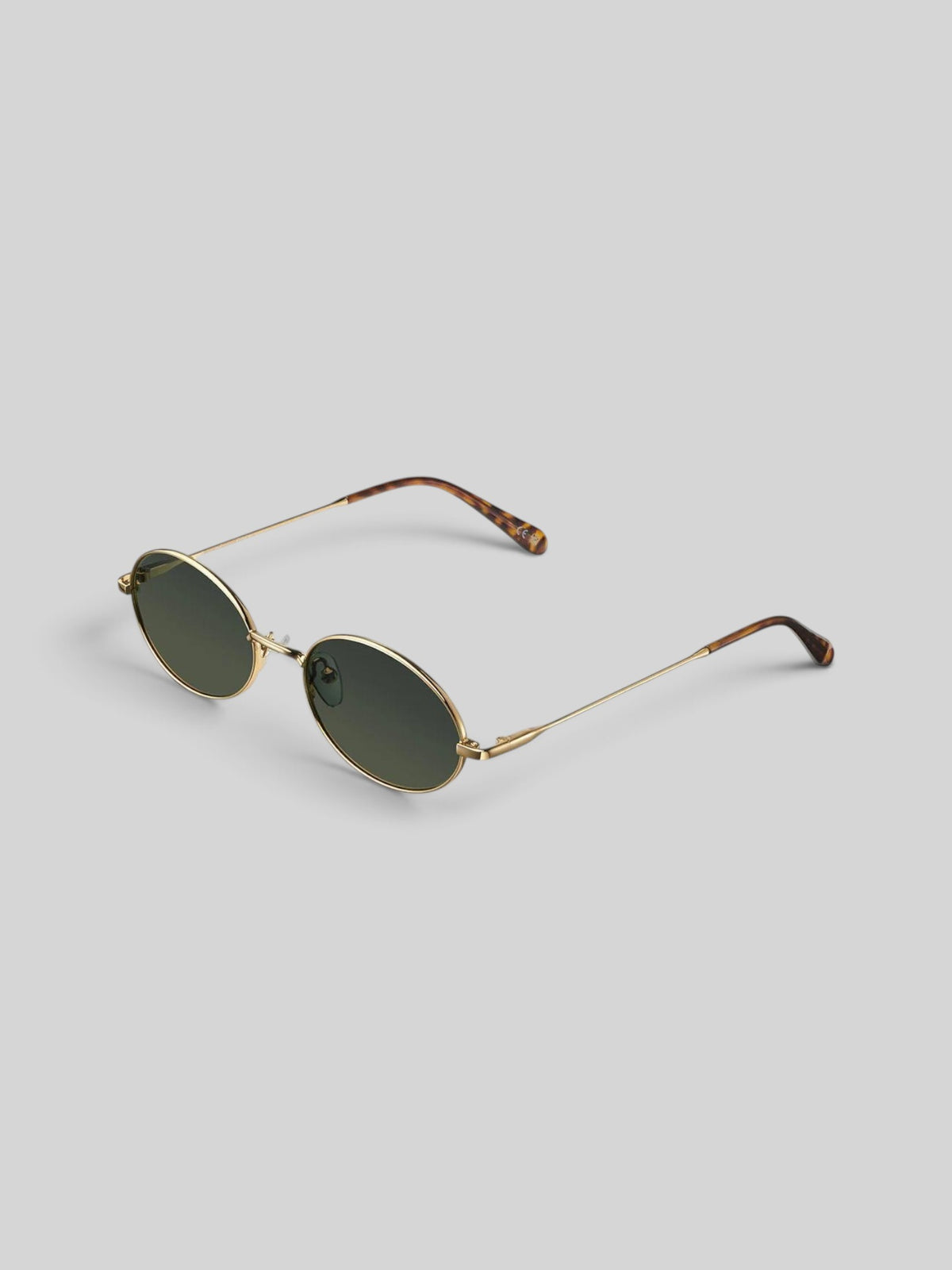 Baffle Haus Amara oval sunglasses with a slim gold stainless steel frame and dark polarized lenses