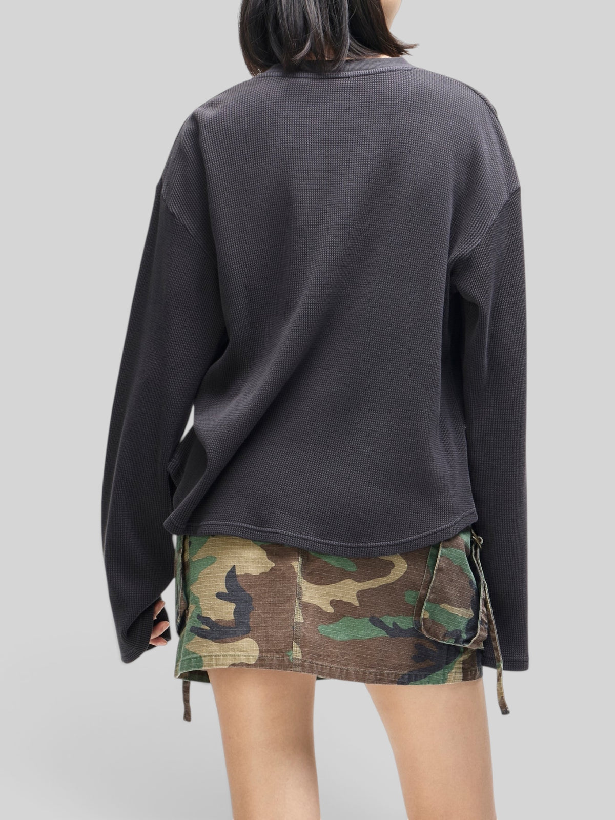 Baffle Haus anthracite grey long sleeve waffle knit top with a relaxed fit, shown from the back on a model.