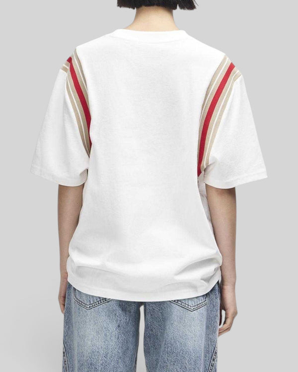 Baffle Haus Debute Tee in antique white with red and beige striped rib sleeve inserts, shown from the back.