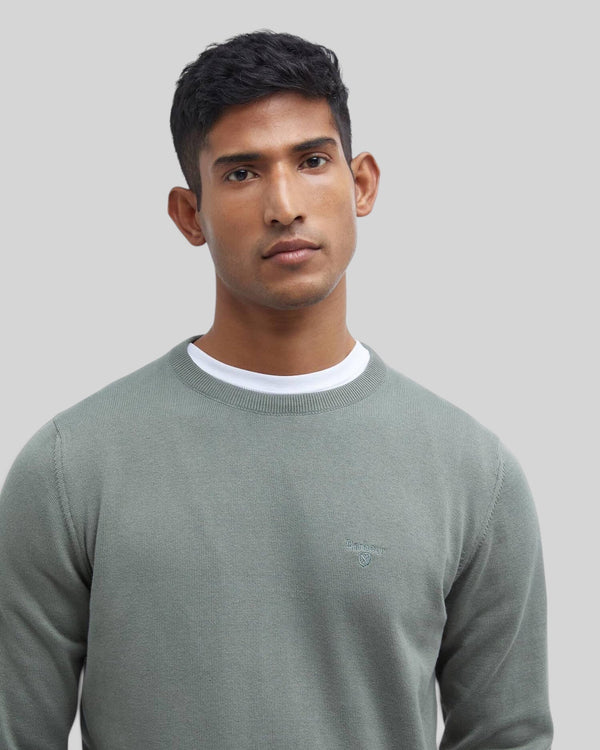 Baffle Haus Barbour agave green Pima cotton crew neck sweater with embroidered logo on chest worn by a man