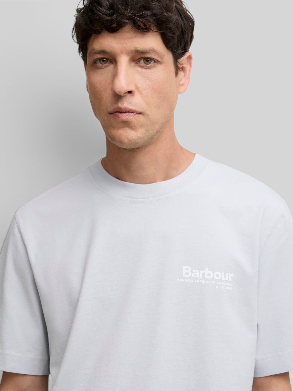 Baffle Haus Barbour Wildfell blue haze cotton graphic t-shirt with small chest logo worn by a male model