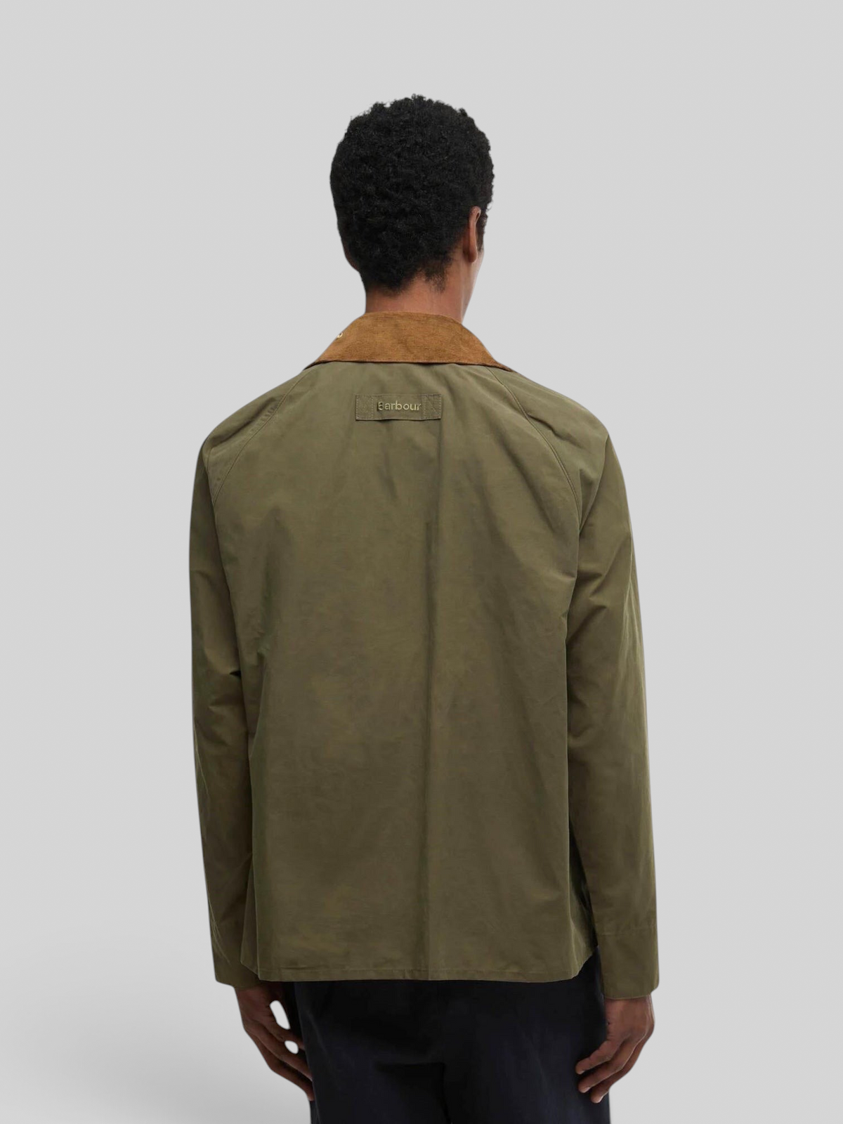 Back view of Baffle Haus Barbour Icons Transport casual jacket in ivy green with a brown corduroy collar.