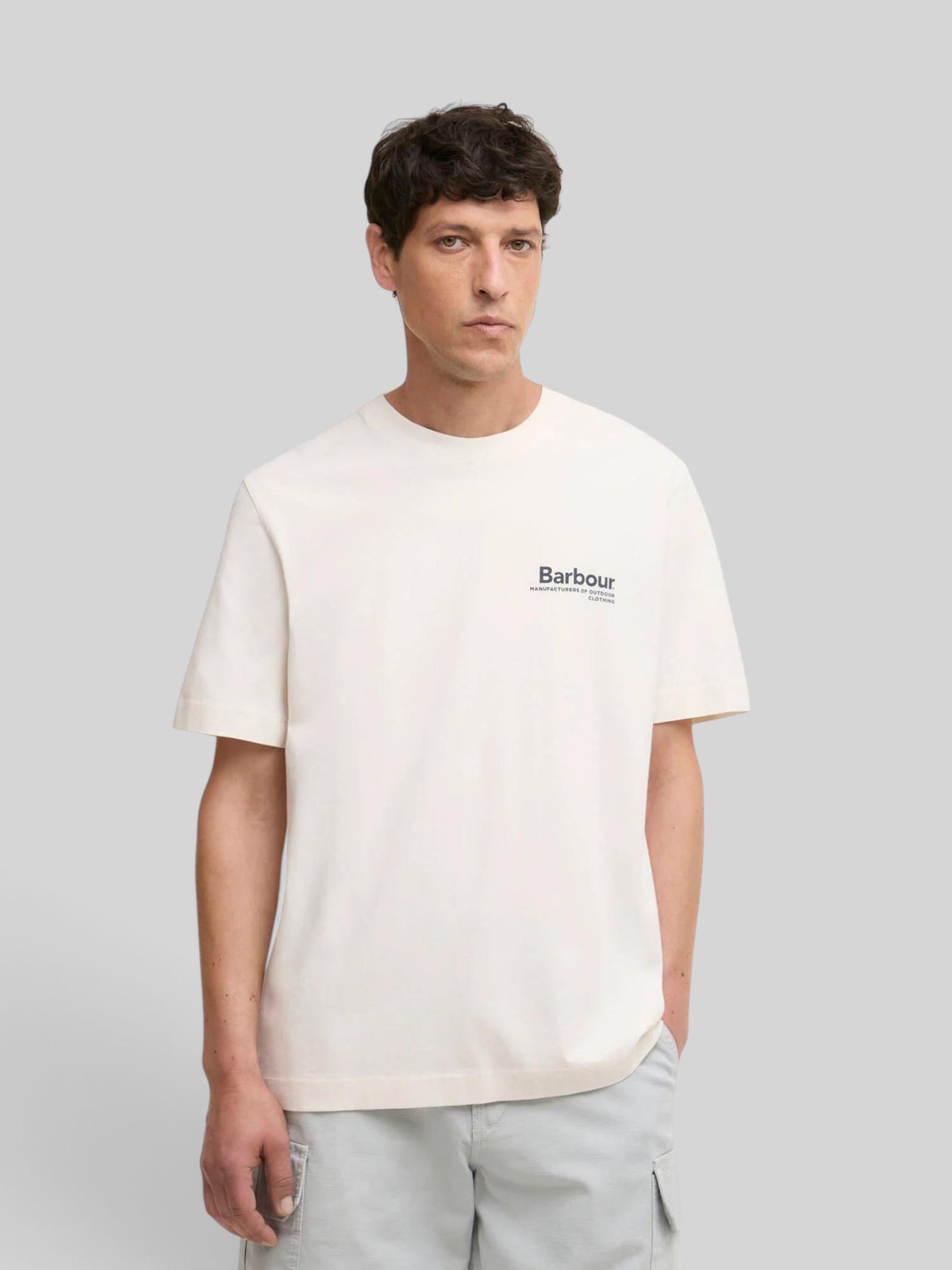 Baffle Haus model wearing a neutral Barbour Wildfell relaxed fit cotton graphic t-shirt with chest logo.