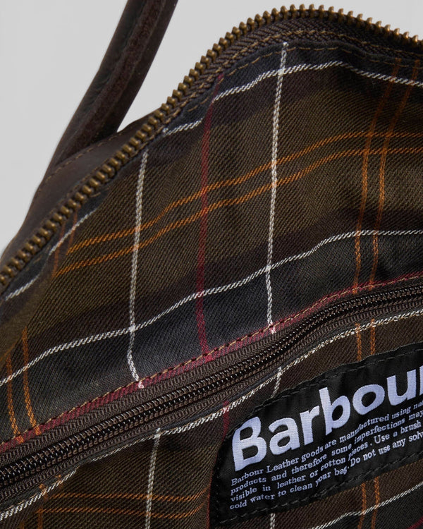 Baffle Haus Barbour Wax Holdall interior featuring classic tartan cotton lining, antique brass zip, and brand label.