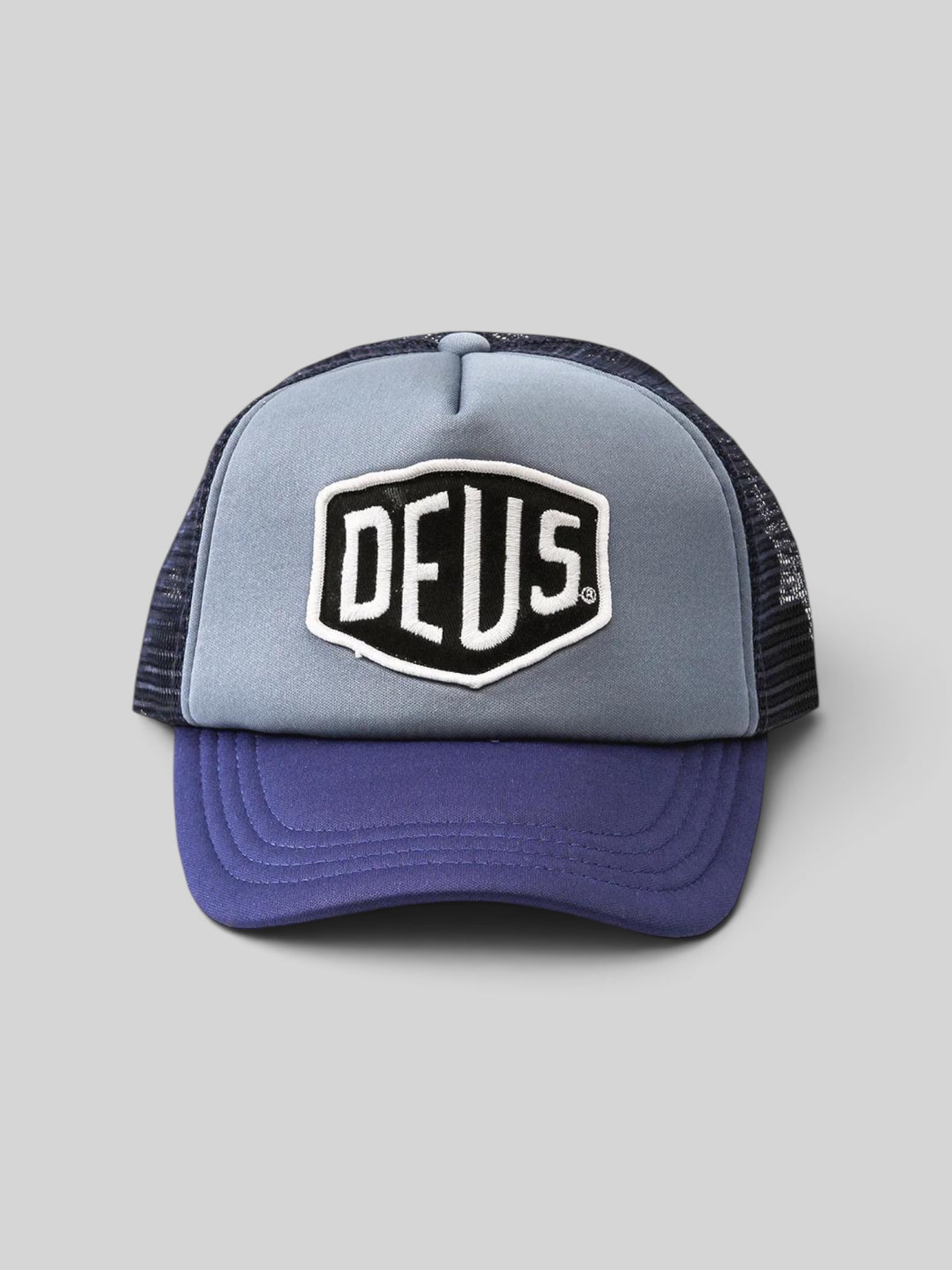 Baffle Haus Baylands trucker cap in blue and navy with a Deus embroidered patch and breathable nylon mesh back