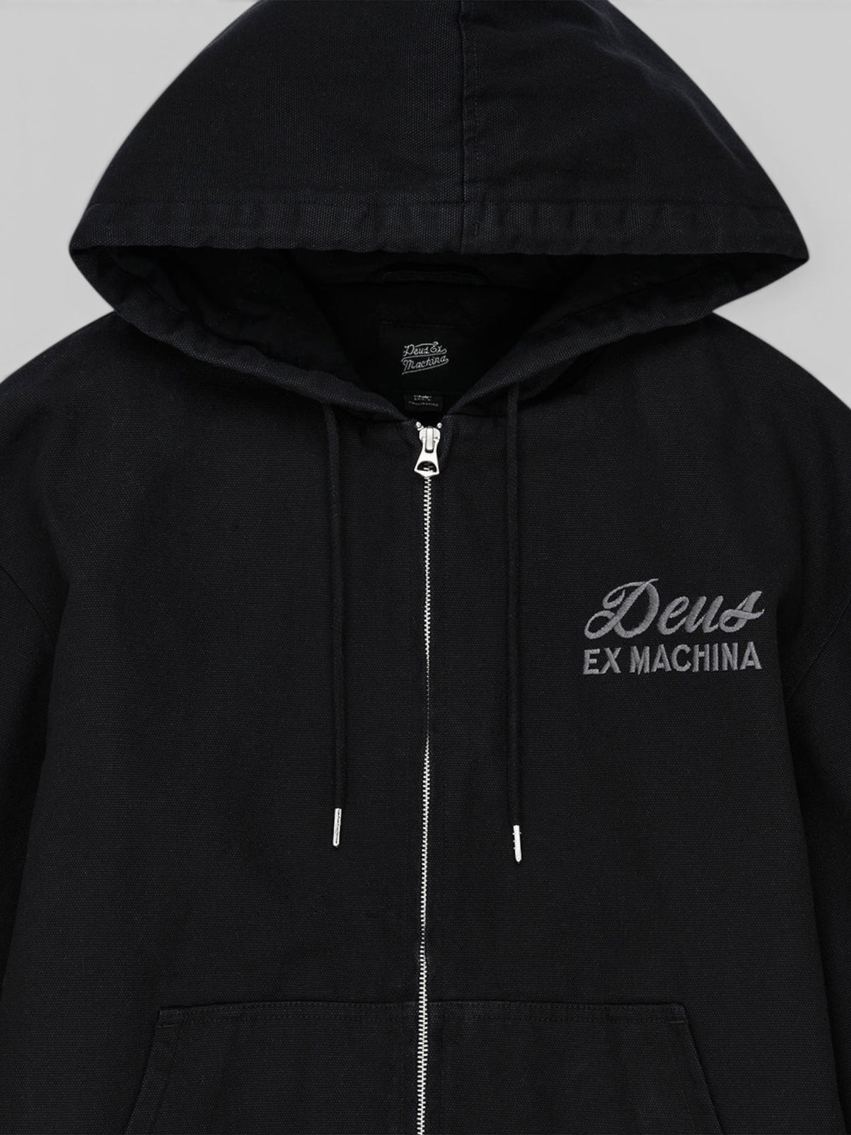 Baffle Haus Harajuku black cotton canvas hooded work jacket with zip front and embroidered Deus Ex Machina logo