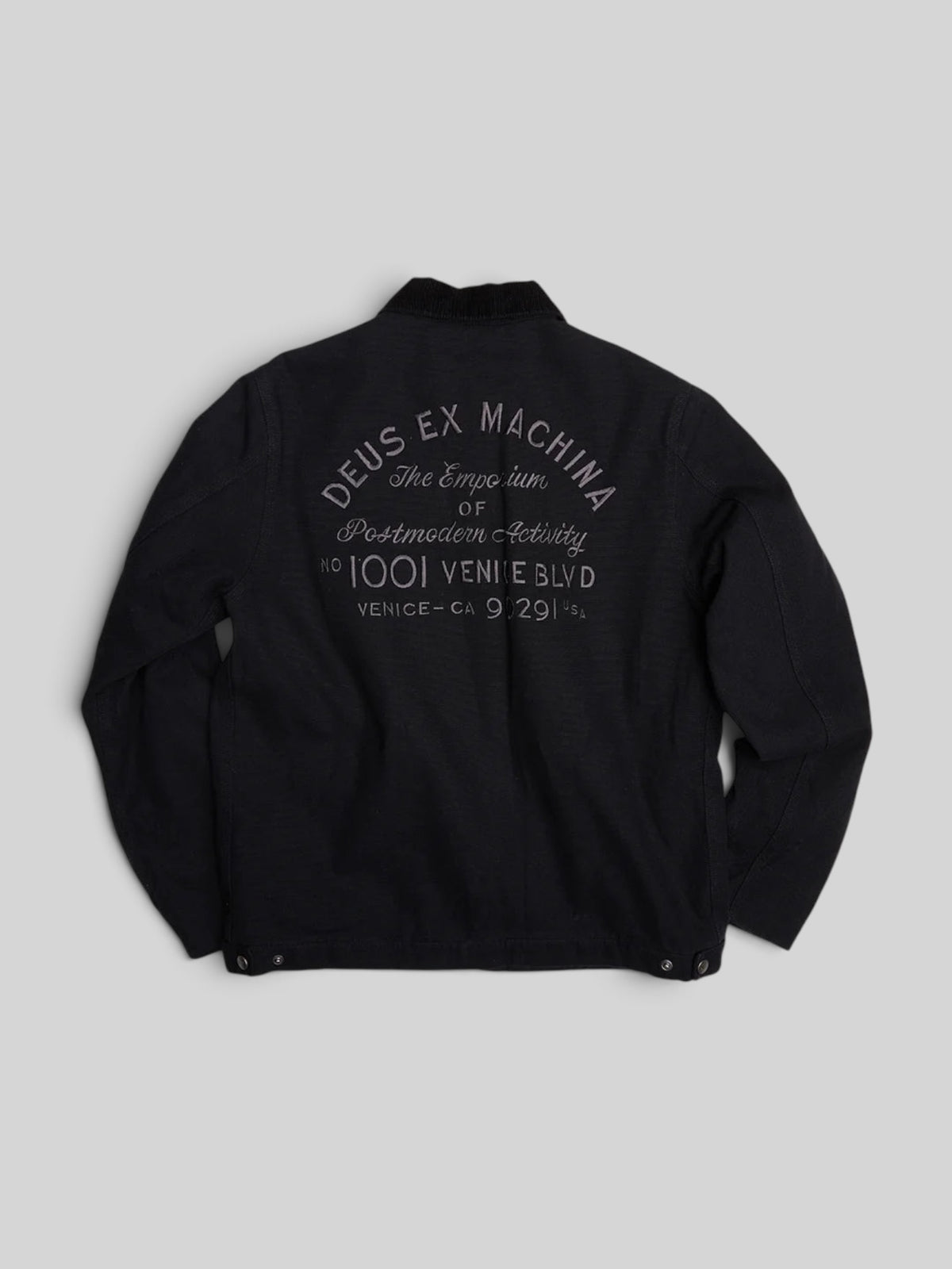 Baffle Haus black cotton canvas workwear jacket with embroidered Deus Ex Machina address logo on the back