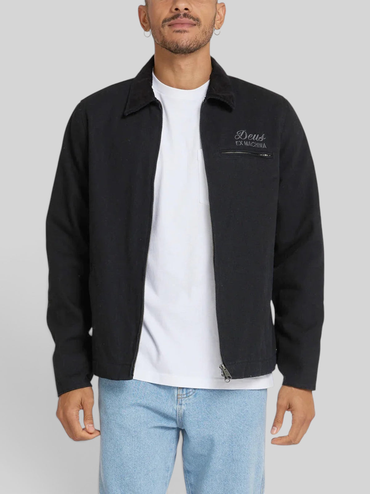 Baffle Haus black cotton canvas workwear jacket with zip closure, collar, and embroidered chest logo on a model.