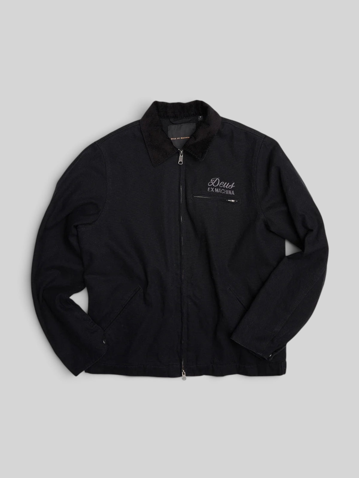 Baffle Haus black cotton canvas workwear jacket with zip closure, corduroy collar, and embroidered chest logo.