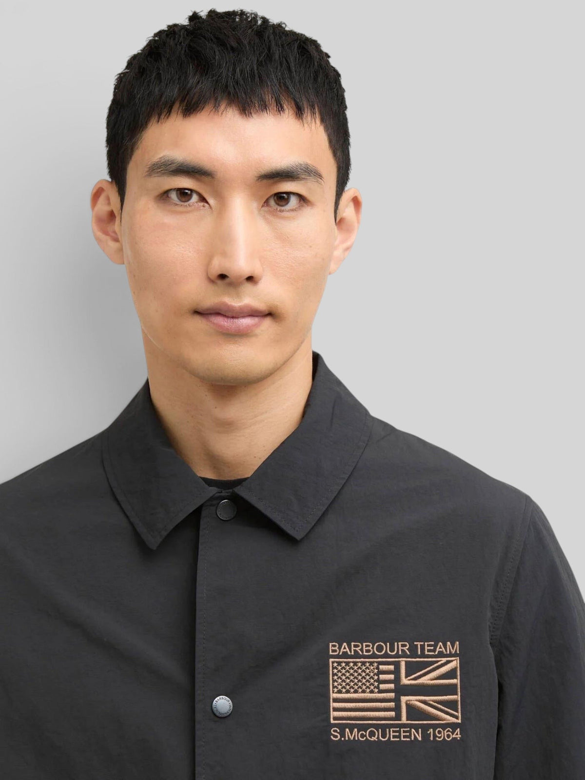 Baffle Haus black B.Intl Coach casual jacket with a sit-down collar and Steve McQueen embroidery on the chest.