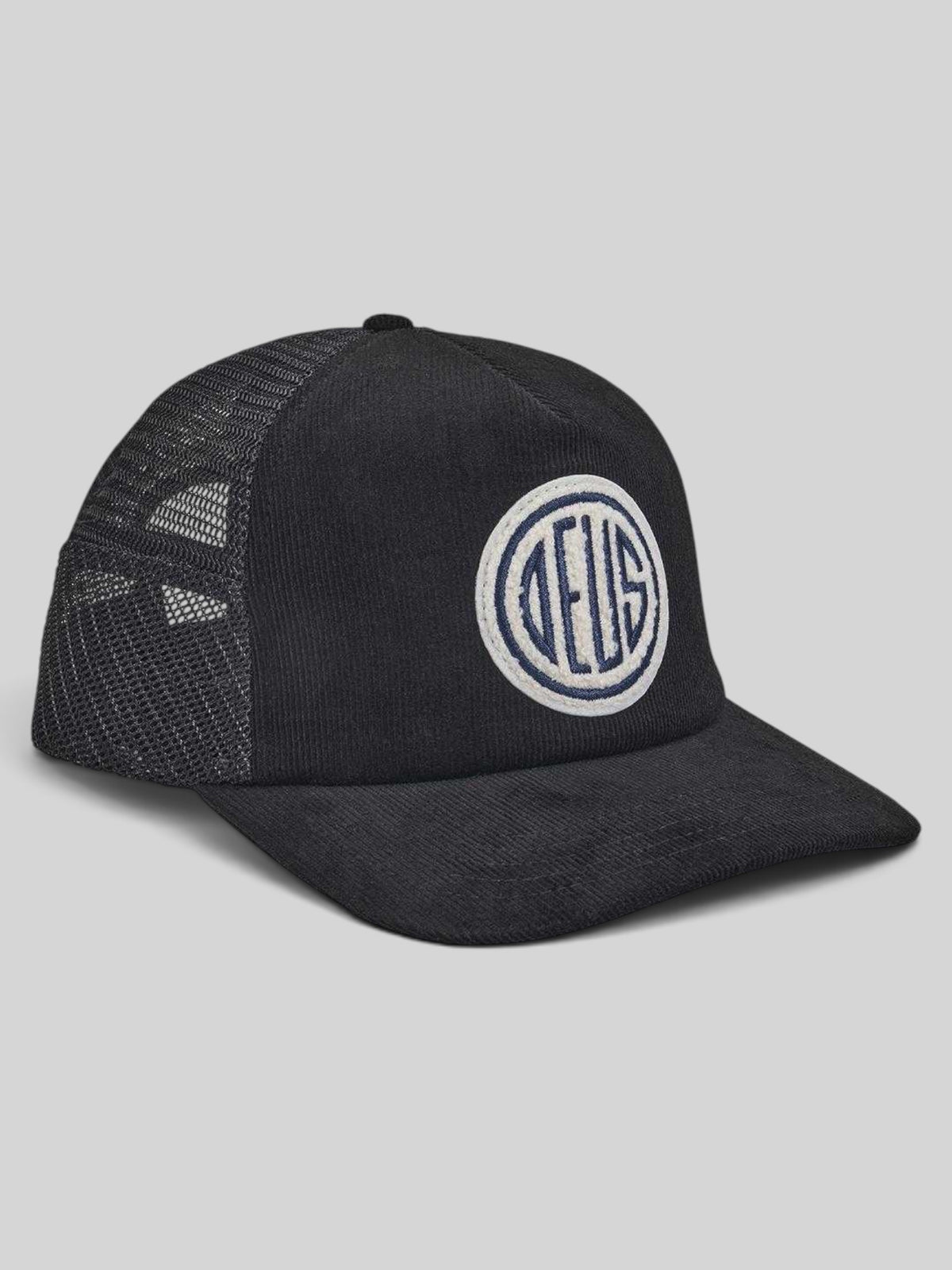 Baffle Haus black cotton corduroy trucker hat with a circular embroidered logo patch and breathable mesh back