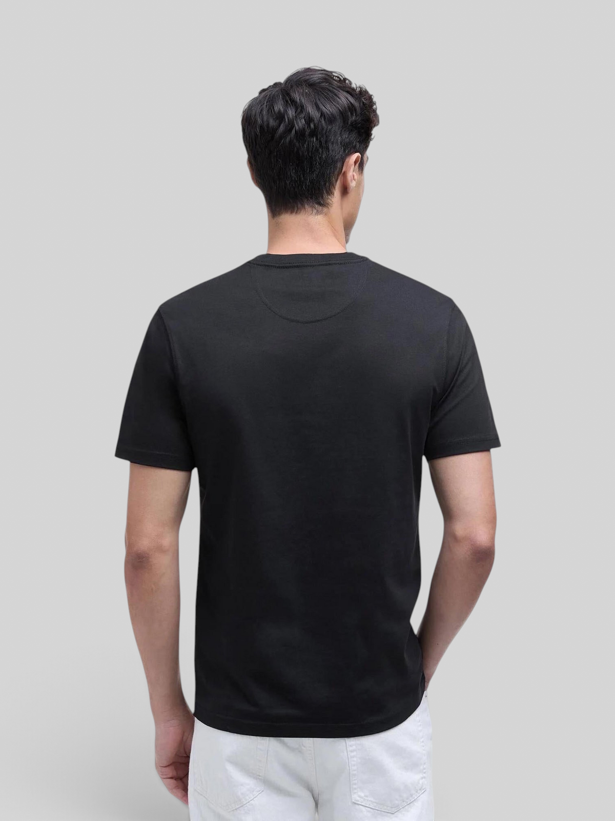 Back view of a man wearing a Baffle Haus black crew neck cotton t-shirt with a tailored fit.