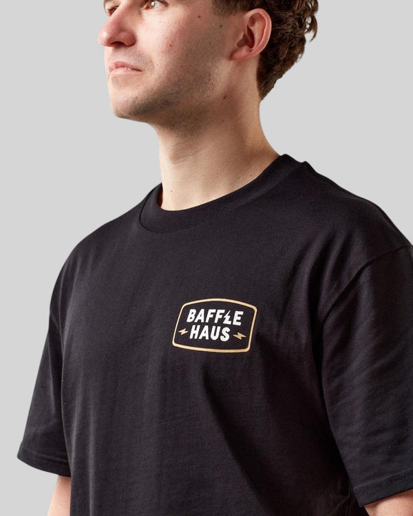 Baffle Haus black cotton t-shirt with Coffee & Motors graphic logo on the chest worn by a male model