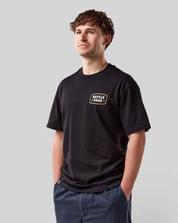 Baffle Haus Coffee & Motors black cotton t-shirt with chest logo worn by a male model