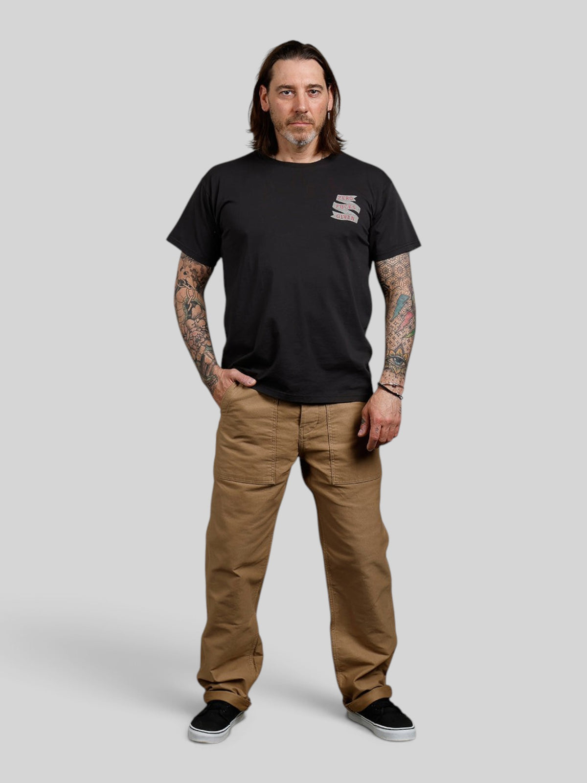 Baffle Haus black 100% cotton t-shirt with Zero F***S chest graphic worn by a man with tattooed arms