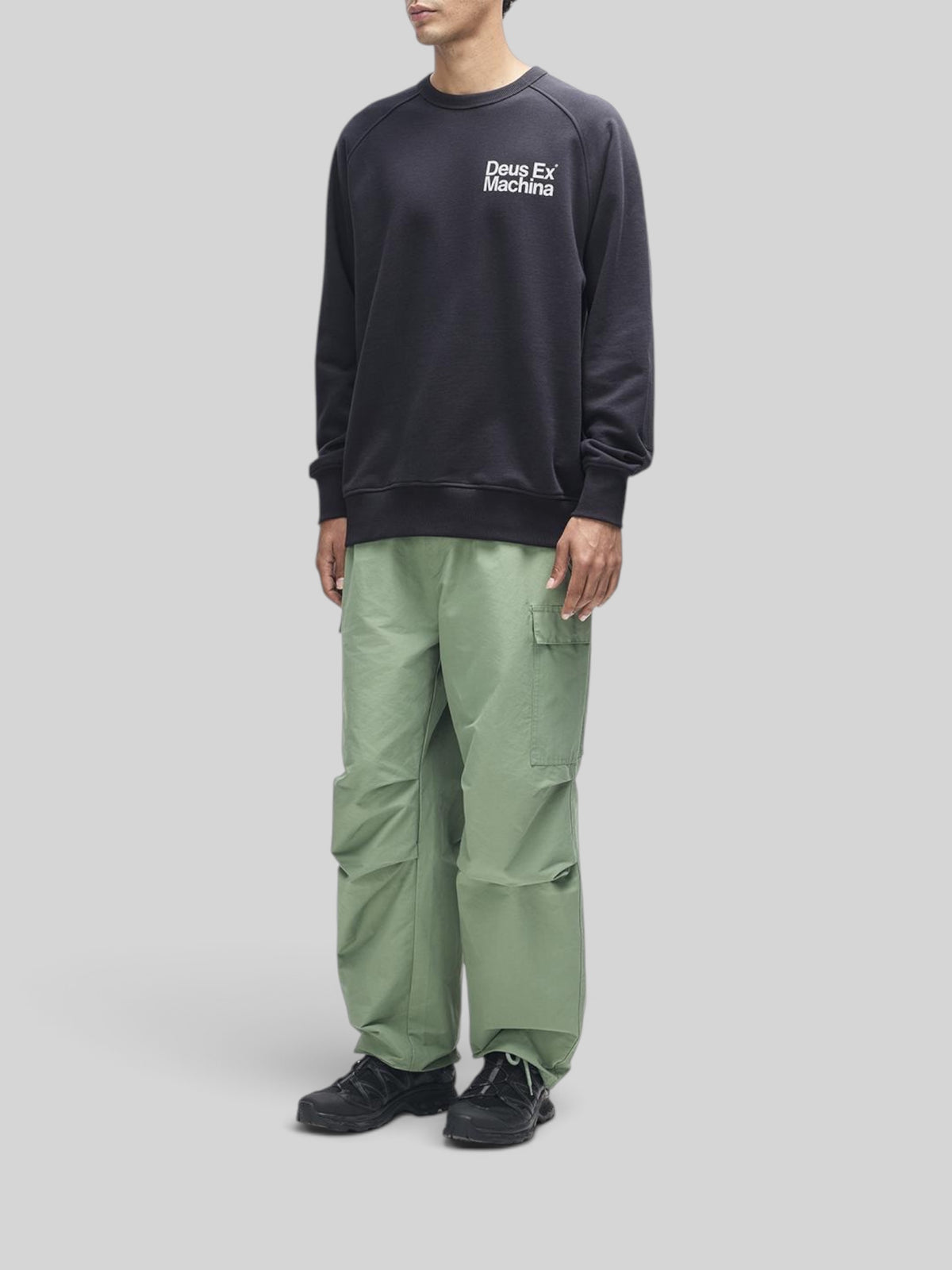Baffle Haus Plenty Good Crew black fleece with chest print and nylon sleeve panels worn by a model