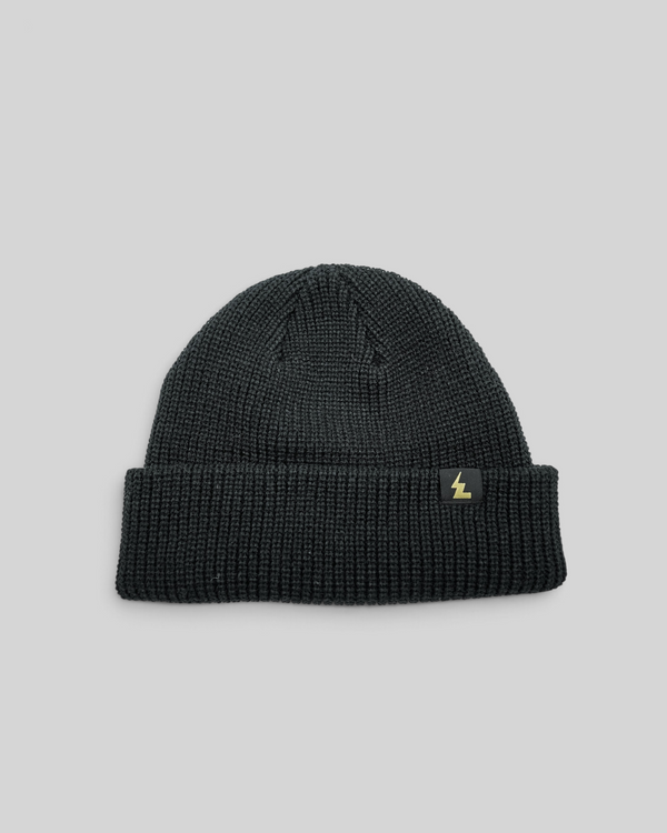 Baffle Haus black fisherman beanie with a short cuff and woven logo label on a white background