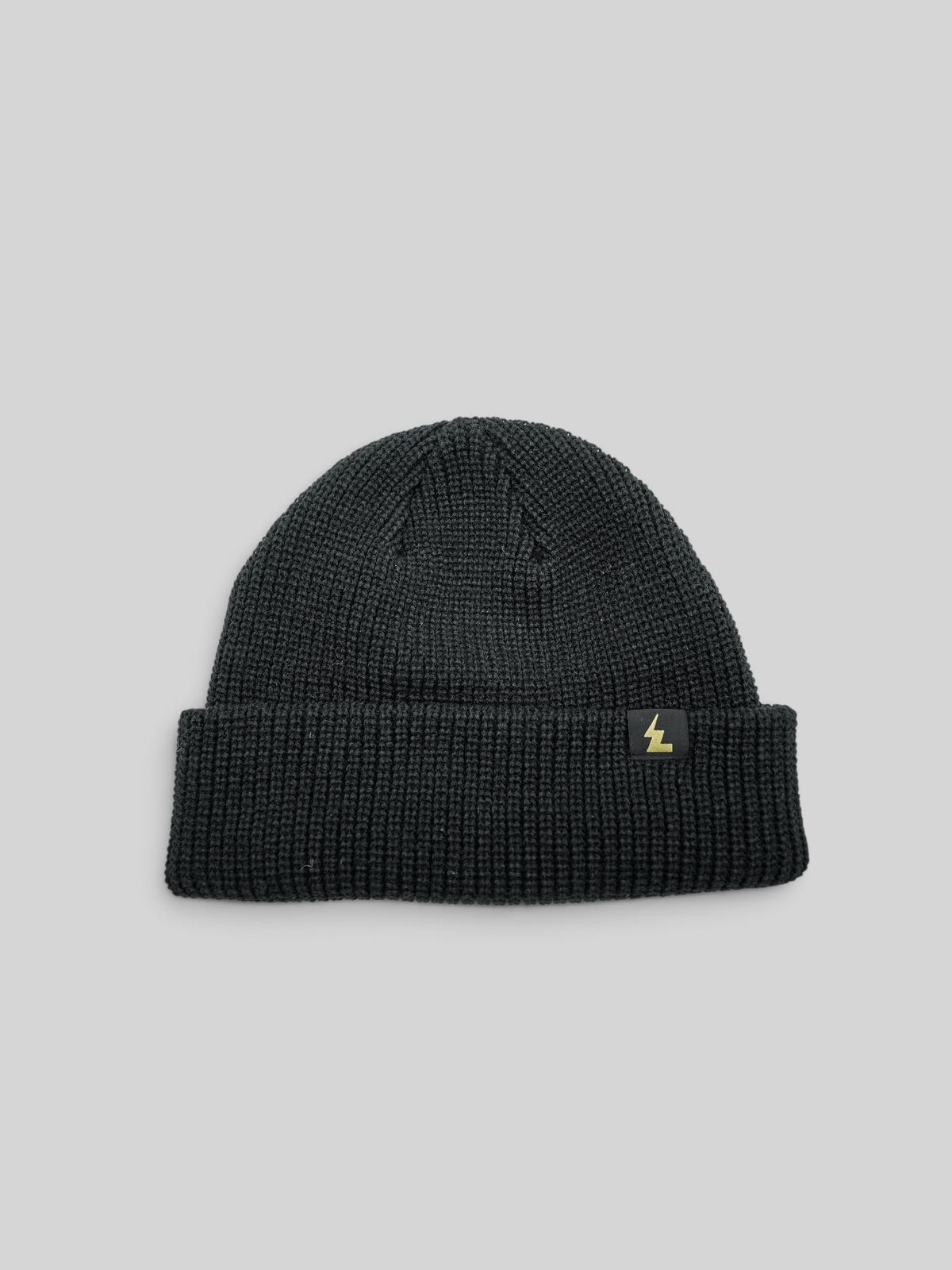 Baffle Haus black fisherman beanie with a short cuff and woven logo label on a white background