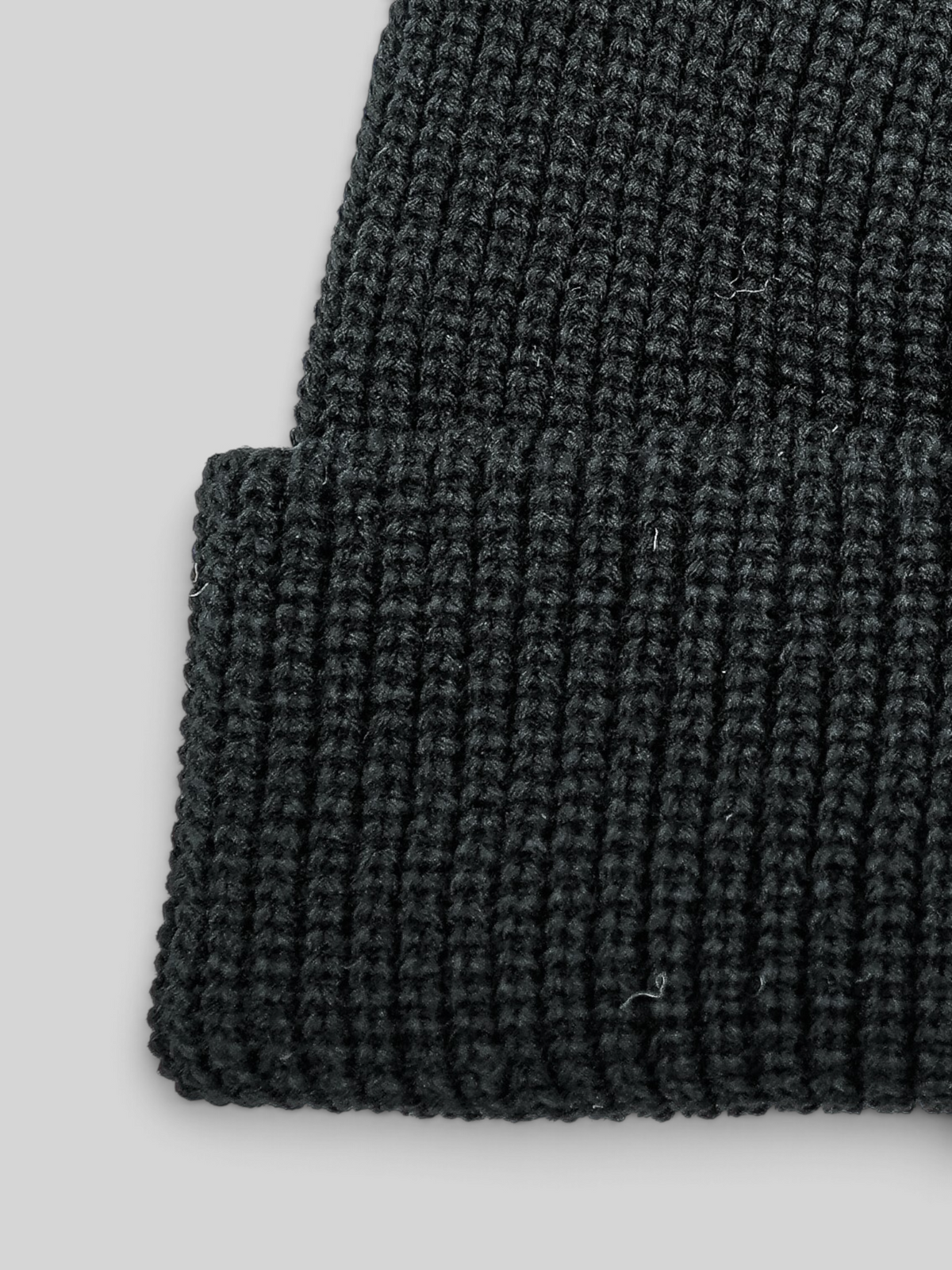 Baffle Haus black fisherman beanie with a short-cuff design and durable ribbed acrylic knit texture.