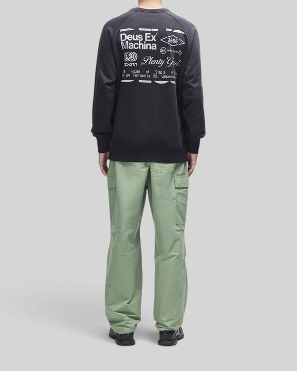 Baffle Haus Plenty Good crew neck fleece in black with white back graphic and nylon sleeve panels on a model