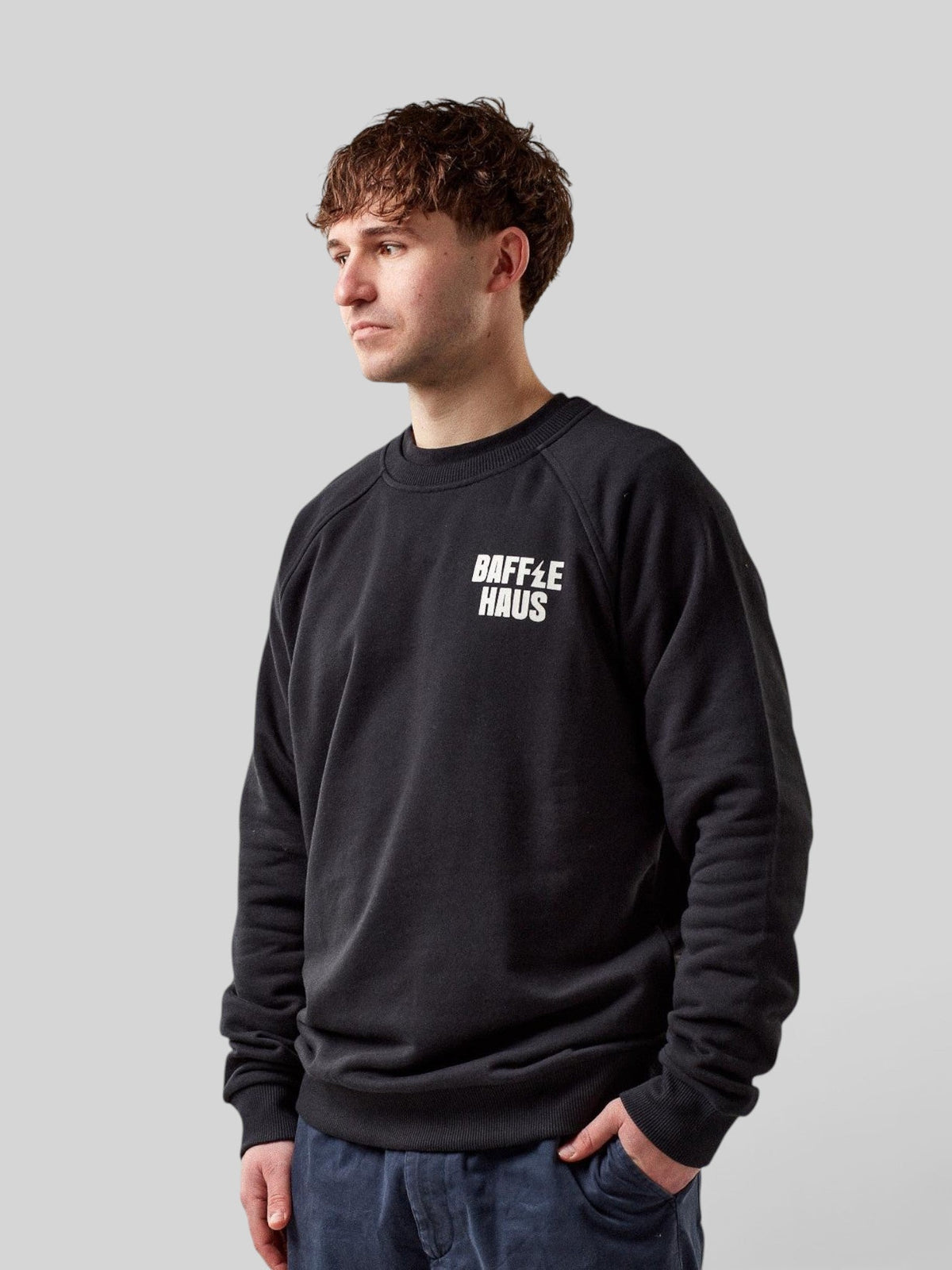 Model wearing a Baffle Haus jet black French Terry cotton sweatshirt with white logo on the chest