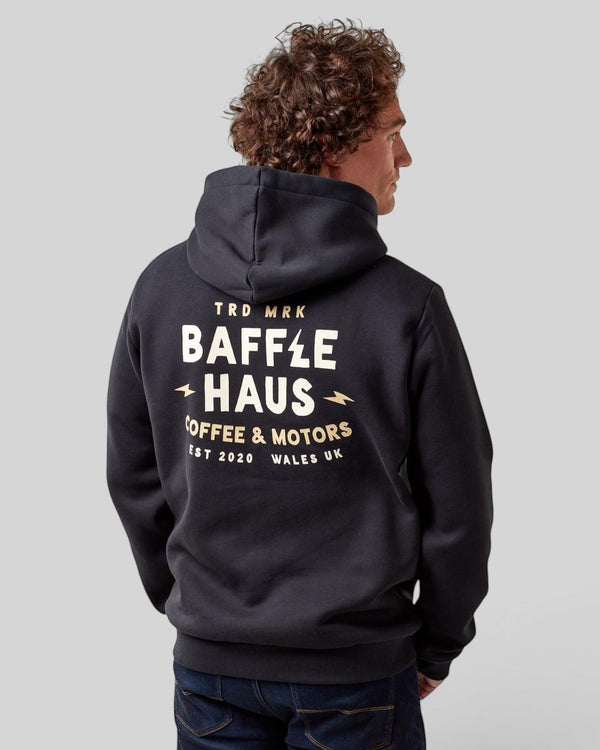 Model wearing a jet black Baffle Haus heavyweight cotton-blend hoodie with Coffee & Motors graphic on the back