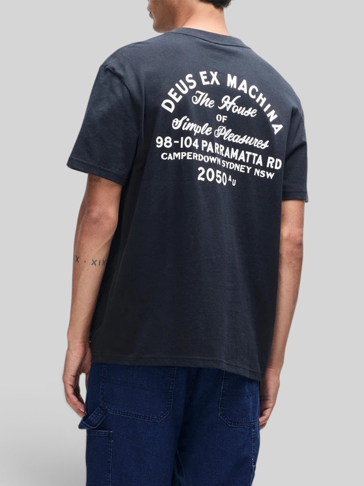 Baffle Haus black organic cotton box fit t-shirt with white graphic print on the back, viewed from behind.