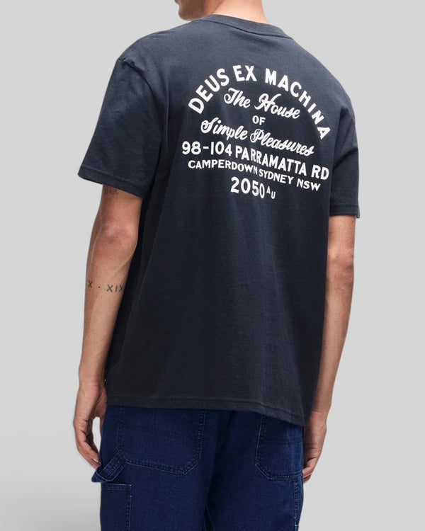 Baffle Haus black organic cotton box fit t-shirt with white graphic print on the back, worn by a man