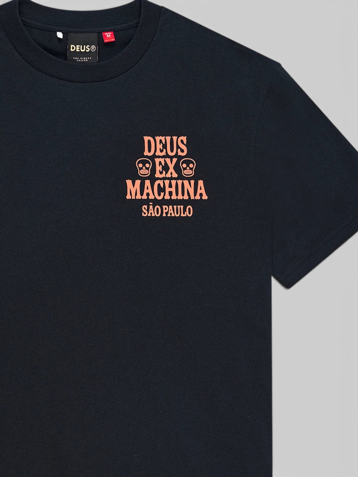 Baffle Haus black box fit tee with peach-colored Deus Ex Machina Sao Paulo graphic print on the chest