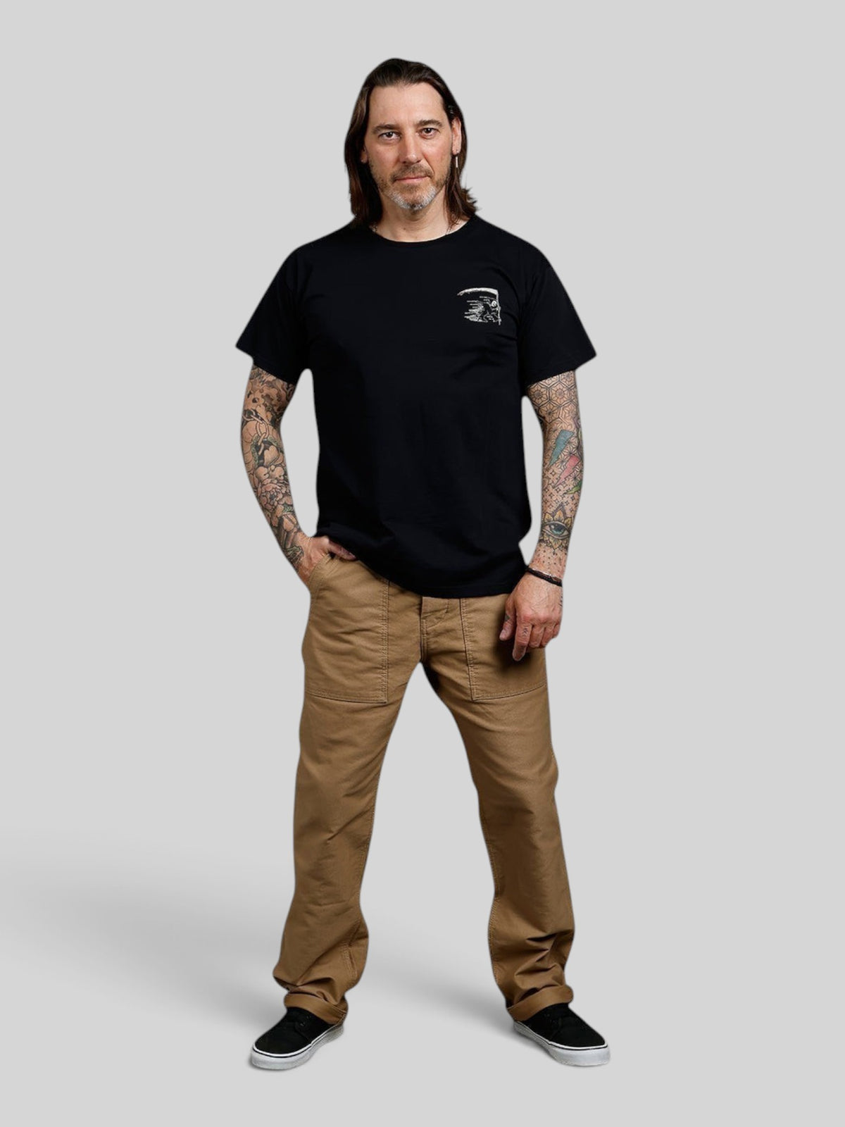 Baffle Haus black 100% cotton sports tee with a small grim reaper chest graphic worn by a tattooed man