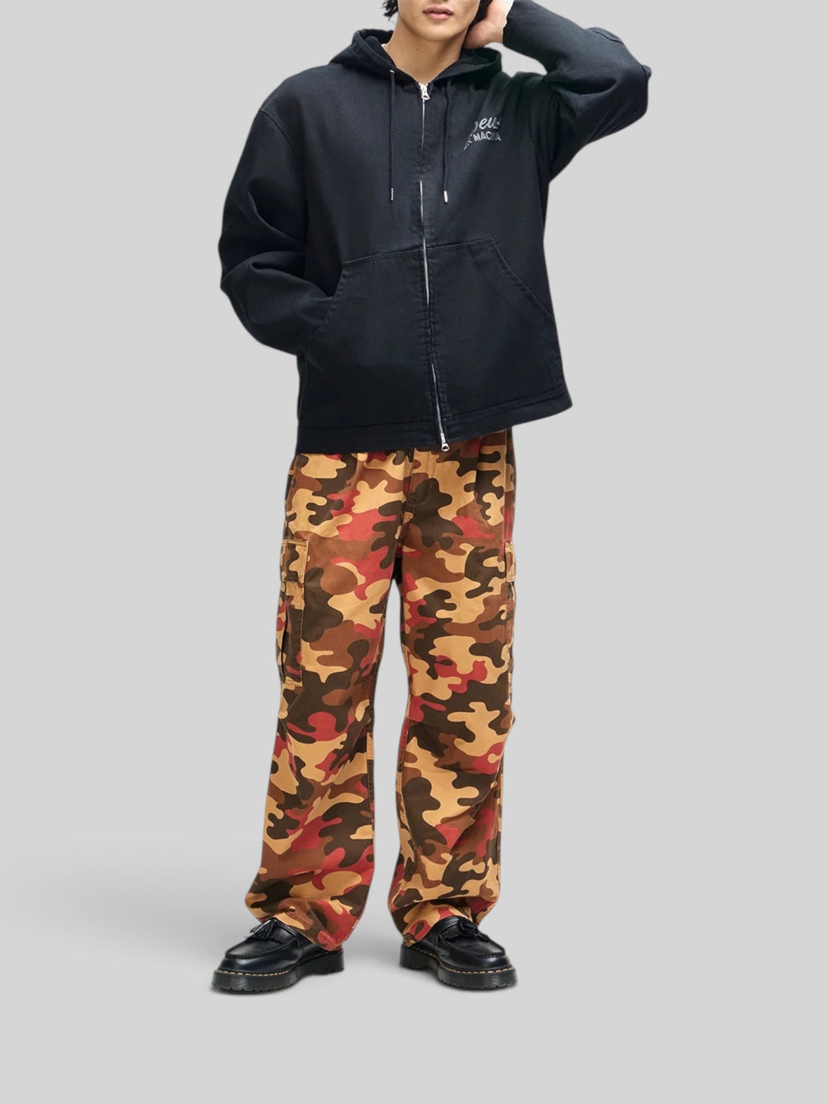 Baffle Haus black cotton canvas hooded work jacket with zip front and embroidered chest logo on a model