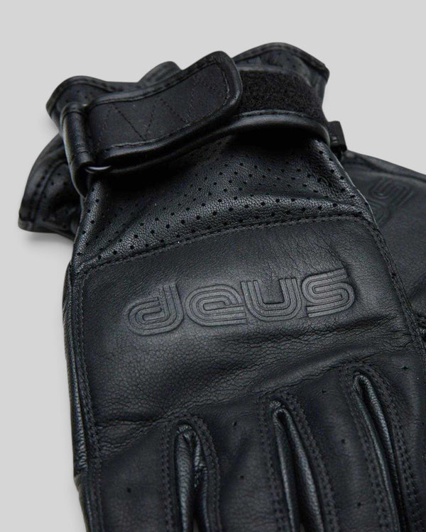 Baffle Haus black goat nappa leather riding gloves with embossed logo, perforated panels, and velcro wrist strap.
