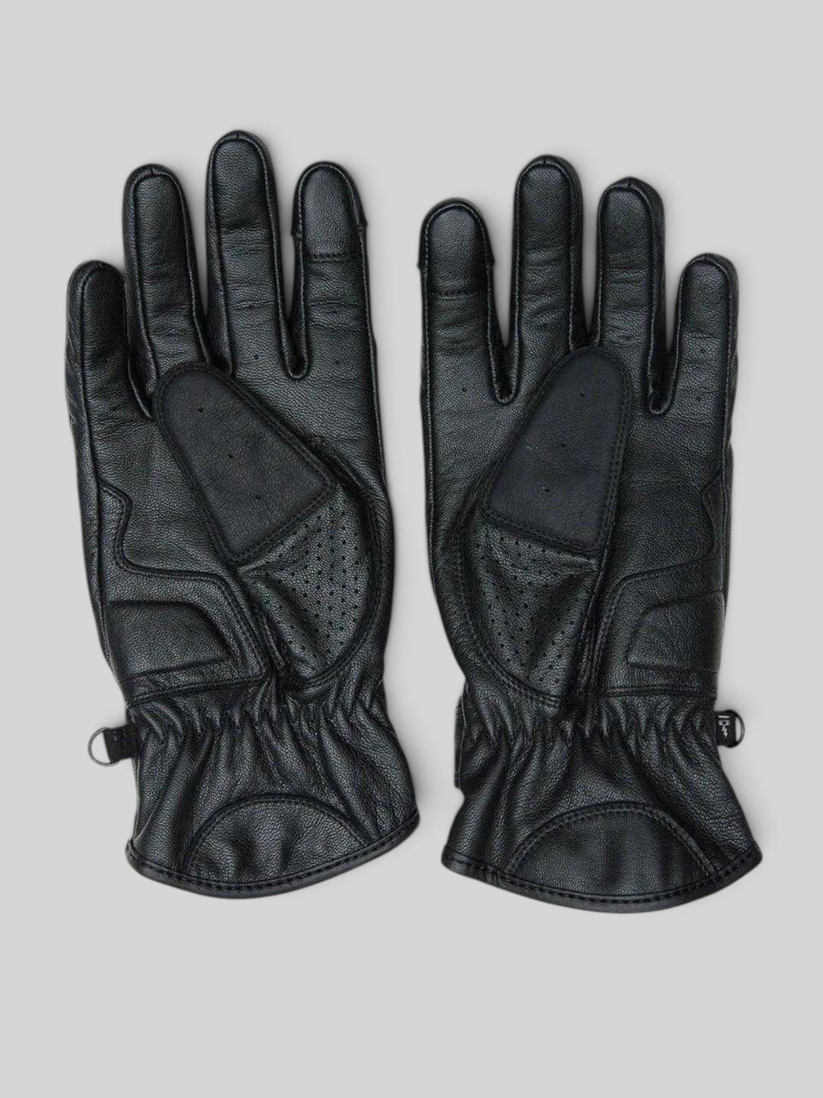 Baffle Haus Rider's Friend black goat nappa leather motorcycle gloves with perforated panels and velcro wrist straps.